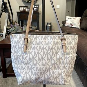 Michael Kors white with blue MK’s.